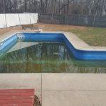 in-ground pool filled with dirty water