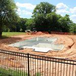 construction of in-ground pool on summer day