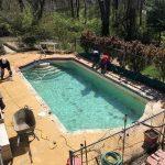 pool in the process of being drained by workers
