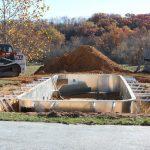 construction of in-ground pool on fall day